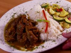 Locals flock to this restaurant for its authentic Jamaican home cooking. Guy enjoyed the "delicious heat" found in the curry goat. The goat head soup was "full flavored" and had tender pieces of goat. The savory and slightly spicy stewed and fried whole red snapper is a fan favorite.