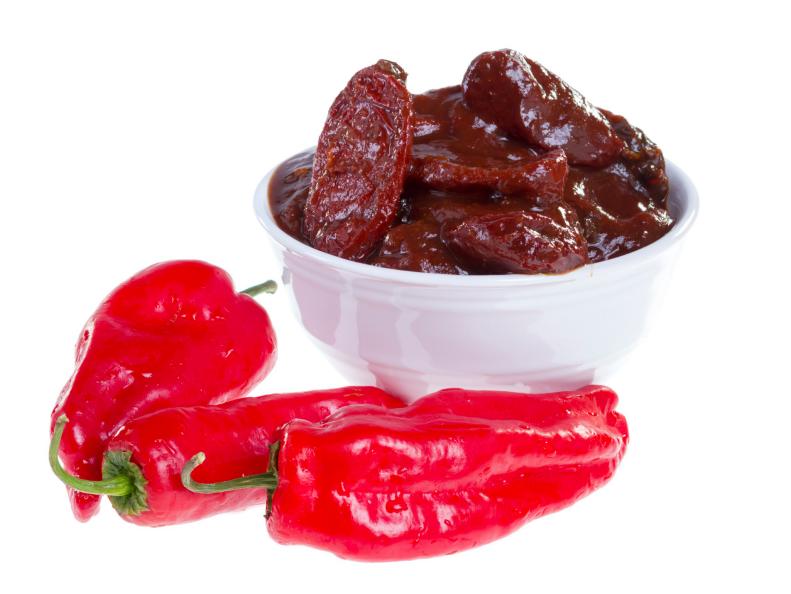 Red jalapeno peppers and chipotles (smoke-dried pods) in adobo sauce isolated on white background.