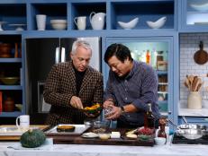 Guest Ming Tsai, right, demonstrates his Kabocha Squash and Shiitake Wontons with Pomegranate-Vinegar Syrup for host Geoffrey Zakarian as seen on Food Network's The Kitchen, Season 7.