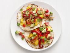 Ready to eat in only 30 minutes, Food Network Magazine's egg-stuffed tortillas feature tender peppers and onions, just like the classic fajitas you know and love.