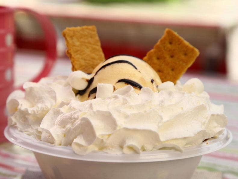 The 7 Layer S'more dessert will leave any sweet tooth satisfied because this multi-layer dessert is made of marshmallow, graham cracker, chocolate, and cookie dough all baked together, as seen on Food Network's Carnival Cravings with Anthony Anderson.