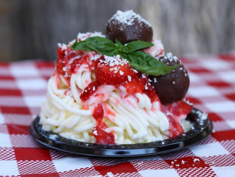 This deceptive dish isn't savory spaghetti but ice cream made to look like a plate of spaghetti and meatballs using vanilla ice cream and brownie balls, as seen on Food Network's Carnival Cravings with Anthony Anderson.