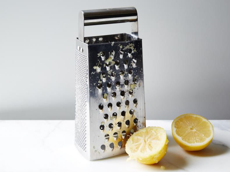 DeGunking a Box Grater with lemon, as seen on Food Network.