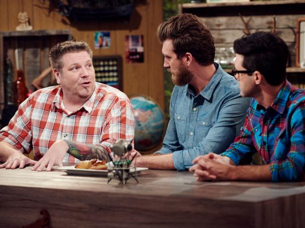 Guest judges Rhett James McLaughlin and Charles Lincoln judge Finalist Rob Burmeister's dish, Hummus, Sausage and Ham Cheese Calzone, during the Star Challenge, Guest Starring on Good Mythical Morning, as seen on Food Network Star, Season 12.