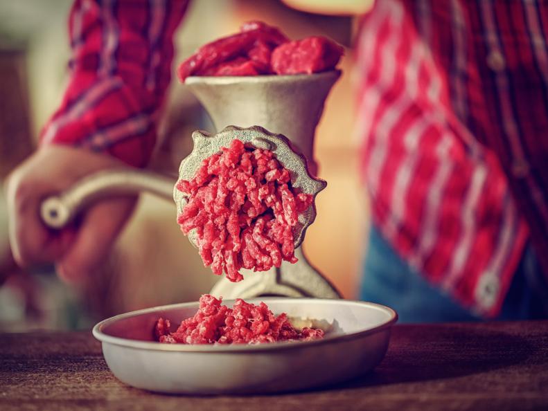 Fresh minced beef and pork meat in a mincer.