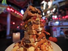 <p>The Vortex is home to a monstrously tall tower of terror called the Super Stack Maniac. The beastly sandwich is built with two pounds of ground sirloin, eight slices of Texas toast, a ton of cheese, bacon, grilled onions and fried eggs and then topped with their signature cheesy cheese goo and barbeque sauces.</p>
