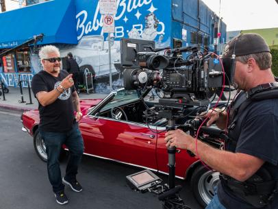 Behind the scenes, Guy Fieri shoots a cold open at Baby Blue's, as seen on Guy's Big Project, Season 1.