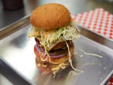 <p>Chef Chris Poetter blends intense Japanese precision and American comfort food to create his towering crunchy burgers. For the Godzilla Attack, a grass-fed beef patty is breaded with panko breadcrumbs and deep fried for a crunchy exterior. The burger is then piled with toppings and a house-made Japanese barbecue sauce and spicy mayo.</p>
