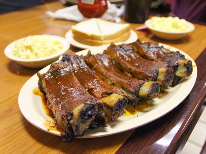 Once a grocery store, Interstate’s oversized dining rooms now lure thousands in for big fat plates of rib tips and elephantine beef ribs. Your plate of already sauced meat comes with your choice of sides – barbecue beans, coleslaw and/or potato salad. The smoked turkey plate — turkey marinated in a blend of spices and served with Interstate sauce — is a special treat.