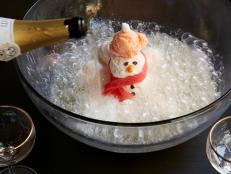 This creamy and cool punch — inspired by a Ramos gin fizz — is a real knockout, complete with a snowman chilling out in drifts of bubbles. To make it ahead, you can assemble the snowman body in advance and pop it in the freezer, adding the scarf just before serving.