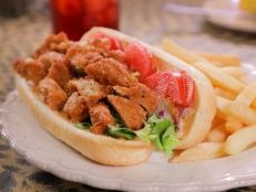 <p>What better place to have old-school comfort food than in a former school building? Patricia Barron of Big Mama's Kitchen serves up her grandma's fried chicken, spicy Afro Burgers and pig ears at this Omaha, Neb., staple. While initially skeptical, Guy quickly became a fan of the Pig Ear Sandwich.</p>