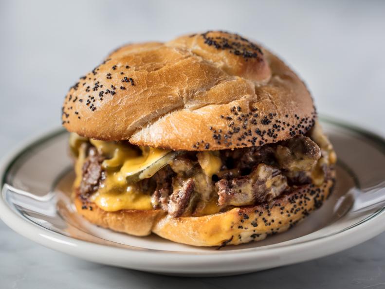One of New York City’s most-beloved dining institutions is the bodega, a corner store that’s responsible for Big Apple classics like the chopped cheese: a cross between a Philly cheesesteak and a cheeseburger. For a gourmet take on the beloved chop cheese, as it’s known locally, stop by White Gold Butchers. A custom poppy seed bun from Terranova Bakery stands in for the usual Kaiser roll. Both sides of the bun are slicked with mayo, then toasted on the plancha before being stuffed with the cheesy, meaty filling. It all starts with a patty made with beef from upstate farm At Ease Acres. A generous ladleful of beef tallow on the griddle adds extra flavor to the patty, which  gets a hard sear on each side before it’s chopped along with housemade pickles and jalapenos. Once the trio is combined, American cheese is melted on top and the whole lot is piled onto the bun. An ice-cold beer perfectly balances the sizzling combo of cheese and meat.