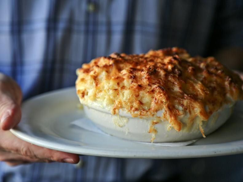 Ask any resident within a 20-mile radius of Raleigh about their favorite cheesy dish, and they’re likely to extol the virtues of the Macaroni Au Gratin from Poole’s Diner. As with the rest of Poole’s menu, Chef Ashley Christensen strikes the perfect balance between the familiar and the fresh to deliver a crave-worthy take on a comfort food classic. Each Macaroni Au Gratin is made to order and features slightly al dente elbow macaroni tossed in a silky sauce made from reduced cream, sea salt and a trio of cheeses: nutty-sweet Jarlsberg, Grana Padano and sharp white Vermont cheddar. The gooey mixture is heaped into an au gratin dish and topped with additional cheese, then broiled to create a crisp golden crust. It’s rare that a table doesn’t request it — the kitchen expects to serve 15,000 orders this year.