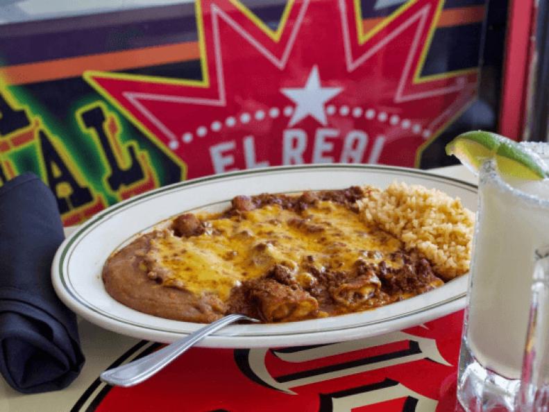 In Houston’s Montrose neighborhood, an art deco building with an oversize neon sign spelling out “Tex Mex” can be seen for miles. It’s a landmark for many locals; the building was formerly home to the Tower Theatre, but since 2011 it’s been El Real, the place for classic Tex Mex cuisine. According to El Real co-owner Robb Walsh, who wrote The Tex Mex Cookbook, all Tex-Mex restaurants are rated first and foremost by their cheese enchiladas. Judging by their legions of fans, El Real’s Cheese Enchiladas #7 are the gold standard. Three corn tortillas are stuffed with cheddar and Land O Lakes® Extra Melt® cheeses, then topped with a blend of yellow and white cheddars, along with chile con carne and chili gravy. In a throwback to the Tex-Mex tastes of the 1950s, the enchiladas are finished with a roux-based sauce studded with chili powder and spices. Craving more cheese? Order the Enchiladas #10, which features El Real’s chili con queso.