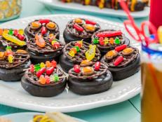 This is the ultimate edible craft project for a barbecue: Chocolate doughnuts and piped chocolate turn into adorable mini grills decorated with all the usual cook-out fare -- only made from candy!