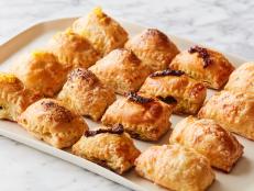 These easy baked appetizers come together quickly and the result is not one, but four very different hand-held bites. The ice cube trays make stuffing and shaping the puff pastry super simple and once you learn the method, you can get creative with your own fillings.
