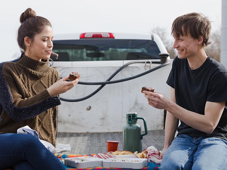Host Molly Yeh and husband Nick Hagen enjoy her Olive Oil Blondies With Chocolate Frosting during a farm lunch, as seen on Girl Meets Farm, Season 1.