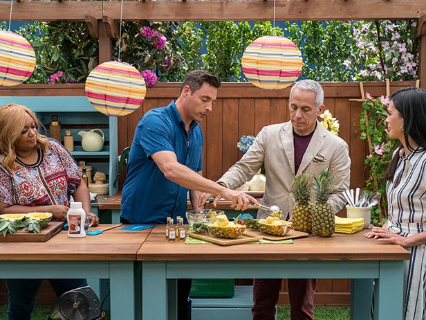 Co-hosts Sunny Anderson, Jeff Mauro, and Geoffrey Zakarian make Party in a Pineapple with co-host Katie Lee, as seen on The Kitchen, Season 17.