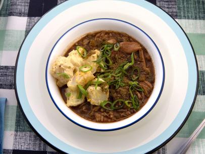 Sam and Cody Carroll's mixed up their favorite style of Chicken Thigh and Smoked Sausage Gumbo and serve it up on a bed of rice with a dollop of potato salad for a Party at the Pond, as seen on Cajun Aces, Season 2.