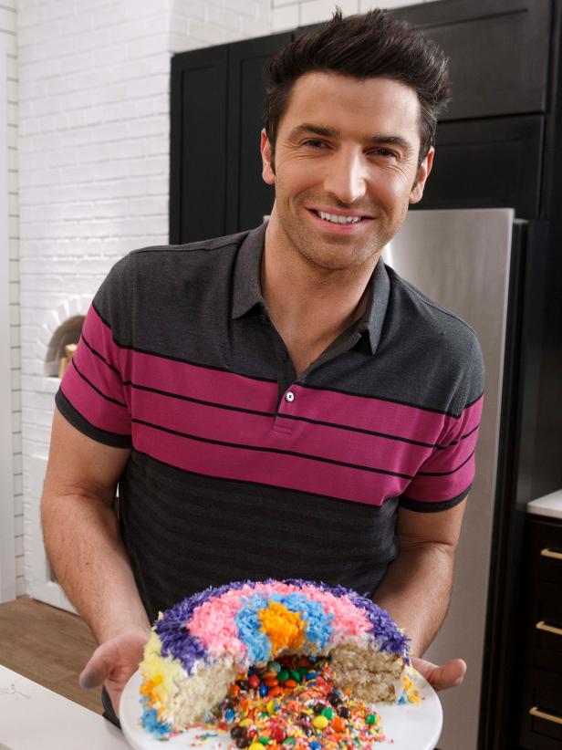 Host Stuart O'Keeffe poses with his Surprise Cake, as seen on Let's Eat, Season 1.