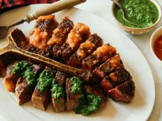 This restaurant-style steak is served carved and dressed in two fresh holiday-hued sauces--salsa roja and chimichurri -- inspired by the two-tone grilled snapper served at the restaurant Contramar in Mexico City. Don't be afraid of generously salting the meat; it helps create a real steakhouse crust.