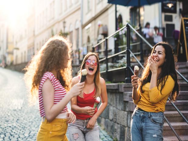 Beautiful teenage girls having fun outdoors in town.