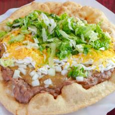These deep-fried, fluffy bread-based tacos are about the size of medium pizza, folded over. Fry Bread House’s Ultimate Taco ($9) is topped with a generous portion of beans, red or green-chili beef, onions, lettuce, sour cream and yellow cheese.