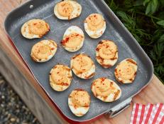 These delicious deviled eggs are packed with smoky flavor. Adobo sauce and smoked paprika spice up the yolks, while a quick trip to a hot grill gives the whites a hint of fire and grill marks.