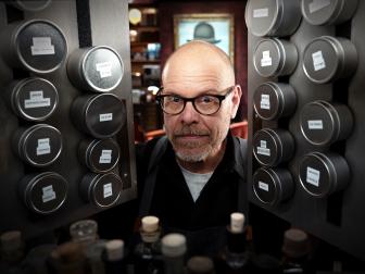 Good Eats: The Return host Alton Brown pops his head into the cabinet.
