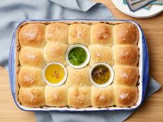 These are classic parker house rolls but with a twist: they're served with a trio of flavored melted butters for dipping.