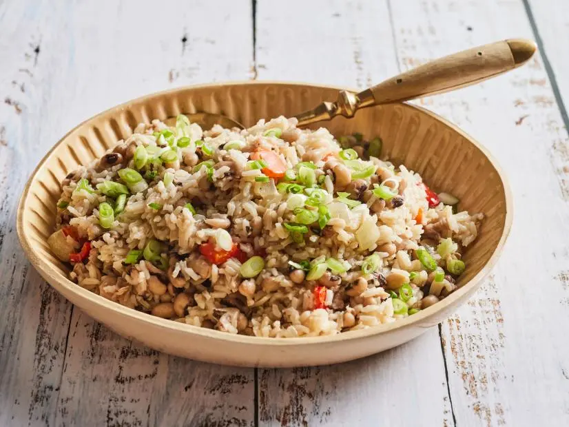Description: Kardea Brown's Hoppin John. Keywords: Black-Eyed Peas, Smoked Turkey, Ham Hock, Onion, Red Bell Pepper, Garlic, Scallions, Long-Grain White Rice.
