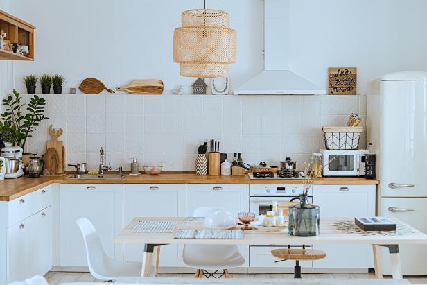 Scandinavian style cozy modern kitchen interior with a dining zone, white modern interior, everyday still llife, stay at home coronavirus quarantine, chores