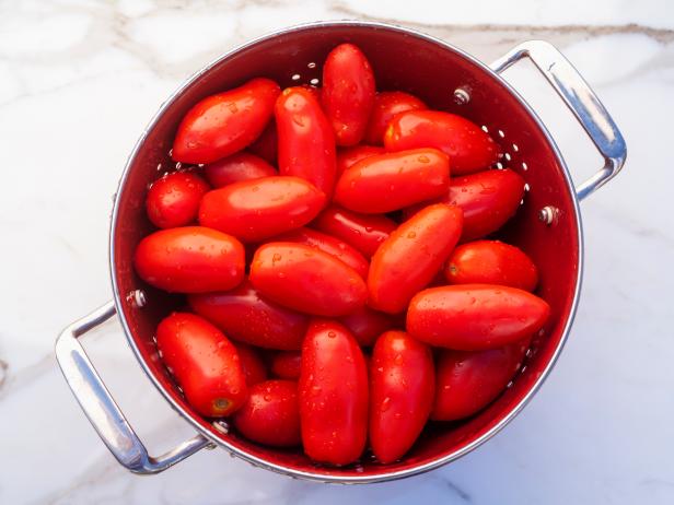 1270494915 a colander of roma tomatoes