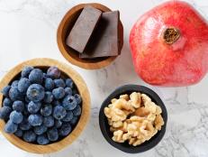 Foods helpful with brain health including blueberries, walnuts, pomegranate, and dark chocolate