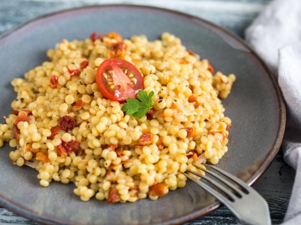 Ptitim or Birdy, Israeli pasta couscous  with tomatoes and herbs/