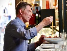 Bobby Flay digs in to chef Nabil Hassen's butter and anchovy pasta, as seen on Bobby & Giada in Italy, Season 1.