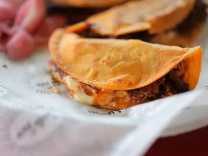 Birria Tacos as served by Santo Taco in Salt Lake City, Utah, as seen on Diners, Drive-ins and Dives, season 34.