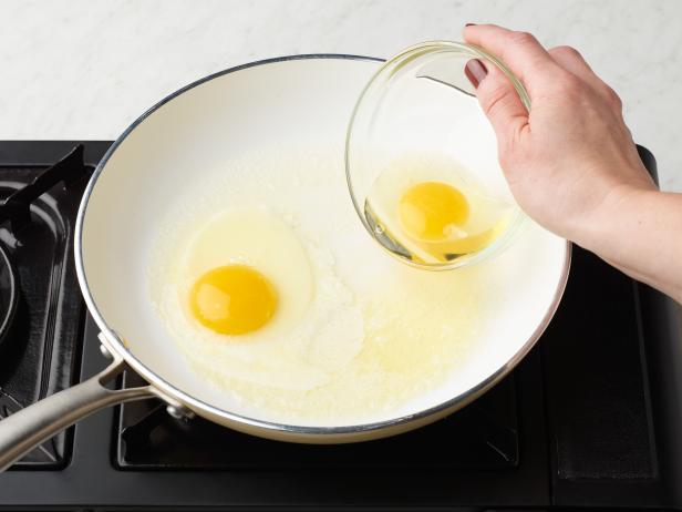 Food Network Kitchen’s How to Fry Eggs A Step By Step Guide Sunny-Side Up Crack the Eggs and Add to the Pan, as seen on Food Network.