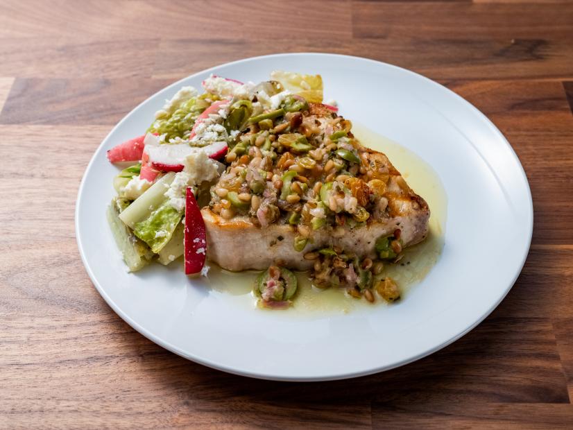 The Main Dish from the Blue Team Demo, featuring grilled swordfish with olive and pine nut relish, grilled romaine salad with sumac, lemon honey vinaigrette, as seen on Worst Cooks In America, Season 24.