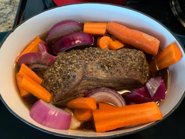 Homemade pot roast in a roaster on top of a stove in Dallas, Texas