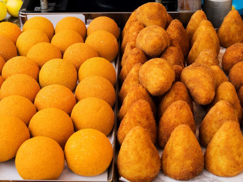 Arancini of rice: sicilian street food. Rice balls stuffed with meat cooked.