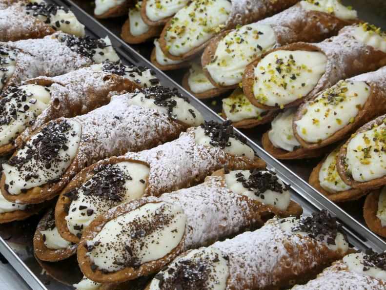 typical Sicilian cannoli stuffed with ricotta and chocolate and pistachio flakes