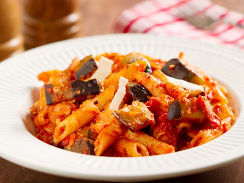 The classic Sicilian dish made with rigatoni pasta, fresh eggplant, onion, basil, olive oil, and mozzarella cheese shavings on top.
