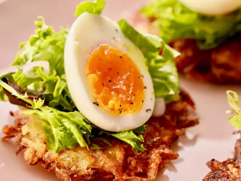 Beauty shot of Molly Yeh's Latkes with Eggs and Greens as seen on Girl Meets Farm, Season 11.