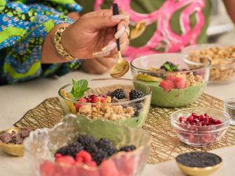 Closeup of Kenya T. Parham adding spoon to smoothie bowl, as seen on The Kwanzaa Menu.