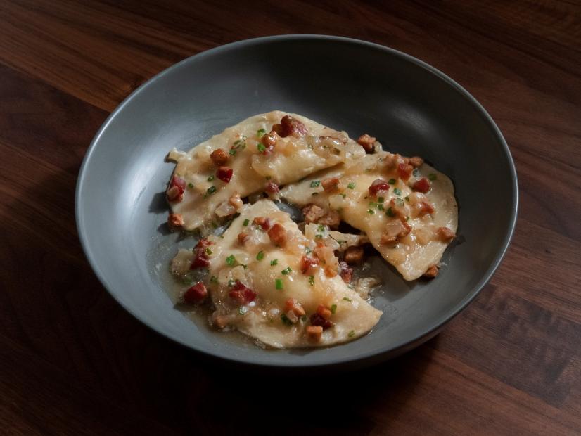Anne Burrell’s Potato and Cheddar Pierogi with Pancetta and Onion Sauce are displayed, as seen on Worst Cooks in America, Season 25.