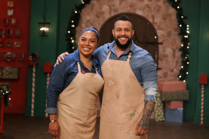 Sweet makers Oralia Perez and Henderson Gonzalez pose together, as seen on The Elf on the Shelf: Sweet Showdown, Season 1.