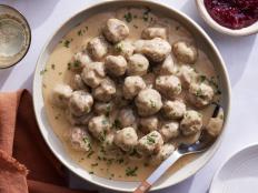 Tender Swedish meatballs smothered in a velvety gravy may be the ultimate comfort food. The secret to making them extra juicy is using a panade, a mixture of starch and liquid that acts as a binder. Here, the torn bread absorbs the milk, then is distributed throughout the meat mix to ensure the meatballs stay moist and tender when cooked. Serve this classic version over mashed potatoes or buttered egg noodles.