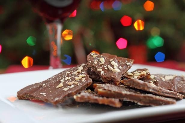 English toffee chocolate candies with red wine near Christmas tee.