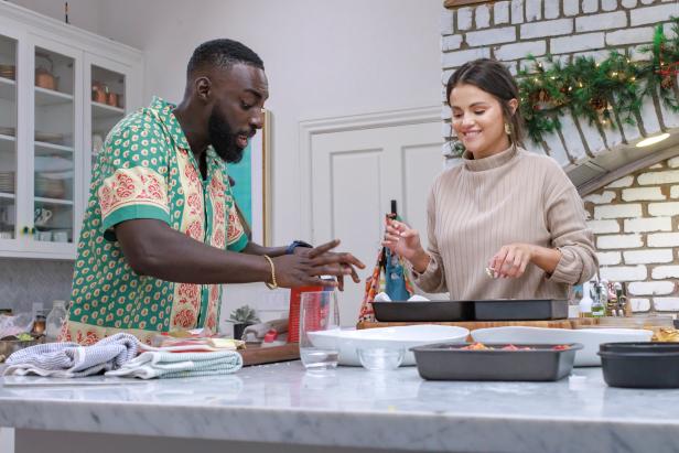 Host Selena Gomez and Chef Eric Adjepong, on Selena + Chef: Home for the Holidays, Season 1.